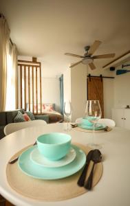 a table with a bowl and a plate on it at Seahorse apartment in Liepāja
