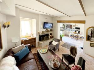 a living room with a couch and chairs and a fireplace at Casa Domenico in Spello