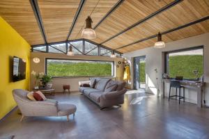 a living room with a couch and a table at PaterMater b&b - La stanza di Rol in CastellʼAzzara