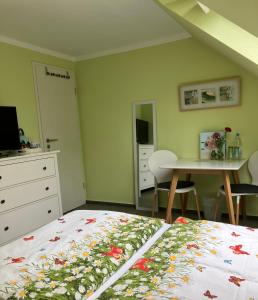 a bedroom with a bed and a table with chairs at Ferienhof BauerMüller in Fehmarn