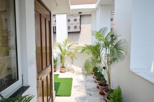 a corridor with potted plants in a building at The Broome Kolkata in Kolkata