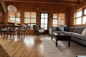 a living room with a couch and a table at Cozy Cabin near Golden Circle - Private Hot Tub in Kotströnd