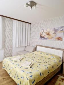 a bedroom with a bed with a flower painting on the wall at Esperanto in Vranje