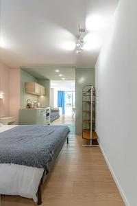 a bedroom with a bed and a kitchen at Newly renovated studio 2 min from Playa La Arena in Puerto de Santiago +18 photos