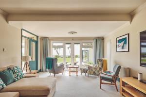 a living room with a couch and chairs at Sun Beach House in Middleton-on-Sea