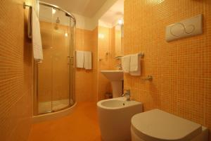 La salle de bains est pourvue de toilettes, d'une douche et d'un lavabo. dans l'établissement Hotel Panizza, à Milan