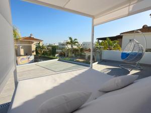 a balcony with a bed and a view of a pool at Sunset Villa private complex heated pool in Ayia Napa