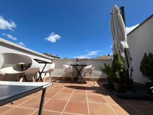 un patio con mesa y sombrilla en Hostal Somnis, en Súria