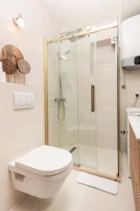 a white bathroom with a shower and a toilet at Apartments Casa Mia in Kotor
