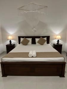 Postel nebo postele na pokoji v ubytování Sigiri Hibiscus Villa
