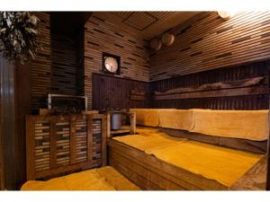 a room with benches and a clock on the wall at Male Only Capsule Hotel & Sauna G-topia - Vacation STAY 70068v in Funabashi