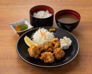 a plate of food with rice and meatballs and a drink at Male Only Capsule Hotel & Sauna G-topia - Vacation STAY 70068v in Funabashi