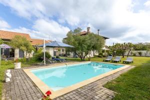 a swimming pool in the yard of a house at Villa Julien in Saint-Julien-en-Born