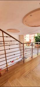 a staircase in a building with a stair railing at Prestigieux Appart-Hôtel Luxury in Kenitra +3 photos