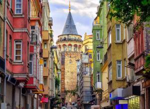 a building with a tower in the middle of a street at Golden Stay Boutique Hotel Taksim in Istanbul