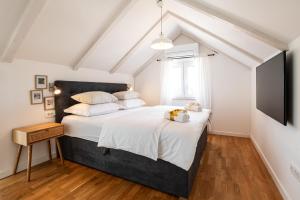 a bedroom with a large bed and a tv at Villa Mista in Sutivan