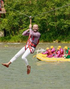 a man jumping in the air on a raft in the water at Kackarsan Vip wooden Suites in Rize