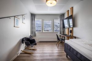 - une chambre avec un lit, un bureau et deux chaises dans l'établissement HOTEL SØMA Nuuk, à Nuuk
