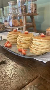 a stack of pancakes on a plate on a table at CORTE CAIAR Bed&Breakfast in Caprino Veronese