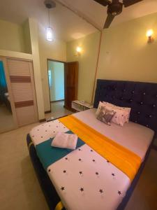 a bedroom with a large bed with stars on it at Modern 1-Bedroom Apartment with AC & Parking along Mtwapa Beach Road in Mtwapa +15 photos