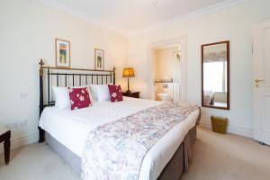 a bedroom with a large bed and a mirror at Waters Edge 1 in Dingle