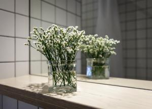 two vases filled with flowers sitting on a table at Melt in Palanga in Palanga