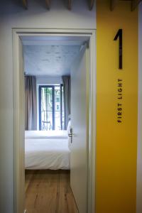 a door leading into a bedroom with a bed at Melt in Palanga in Palanga