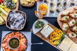 a table topped with plates of food and pasta at HOTEL SØMA Nuuk in Nuuk