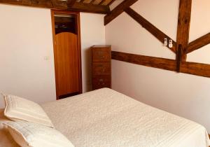 a bedroom with a bed and a dresser at Le Residenze dei Serravallo in Trieste