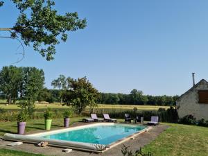 una piscina en un patio con sillas y una casa en L'Aupinouse Chambre double Giroflée avec salle de bain privative, en La Suze-sur-Sarthe