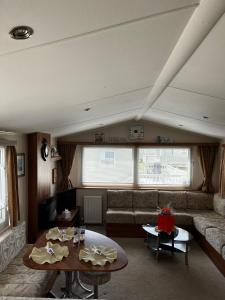 a living room with a couch and a table at Seaview Holiday Rentals - Seawall in Whitstable
