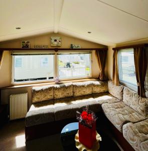 a living room with a couch and a table at Seaview Holiday Rentals - Seawall in Whitstable