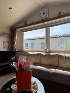 a living room with a couch and a large window at Seaview Holiday Rentals - Seawall in Whitstable