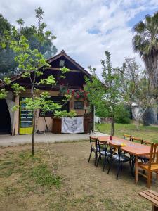 a table and chairs in front of a house at 7 Garden Bungalow / Camping in Kumluca