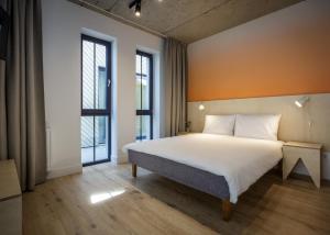 a bedroom with a bed and a large window at Melt in Palanga Self check-in in Palanga