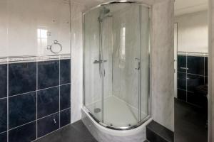 a shower in a bathroom with a glass shower stall at Ideal 3 Bed Home In Glasgow City With Free Parking in Glasgow +34 photos