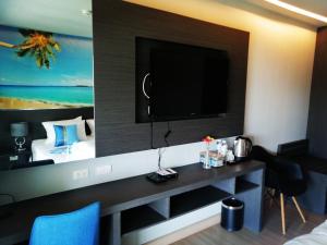 a hotel room with a television on a wall at AD Resort Cha-am/Huahin by room951 in Ban Bo Khaem