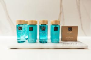 a group of four bottles of toothpaste and a box at City Hotel Dubrovnik in Dubrovnik