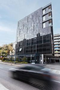 a car driving past a building on a street at City Hotel Dubrovnik in Dubrovnik
