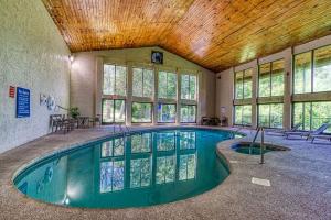 a swimming pool in a building with a ceiling at Pool-Pinecrest Townhomes-1King-2Queen Unit in Pigeon Forge