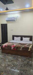 a bed sitting in a room with at Bharat hotel in Ambikāpur