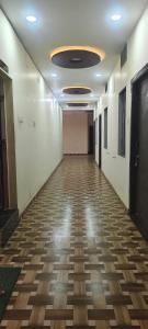 an empty hallway in an office building with a ceiling at Bharat hotel in Ambikāpur