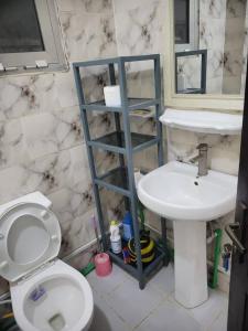 a bathroom with a white toilet and a sink at Appartement Tout Confort en Centre Ville de Kaloum in Conakry