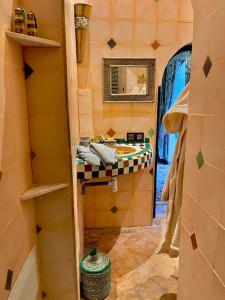 a bathroom with a sink and a mirror at Riad Ta'achchaqa in Marrakesh