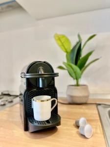 a coffee maker sitting on a counter with a cup at Double Studio A305 StayInn by Cosmopolis in Ştefăneştii de Jos