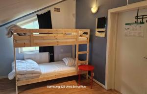 a bedroom with a bunk bed with a ladder at Charlottsborgs Camping, Vandrarhem och Ställplats in Kristianstad