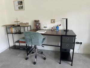 a desk with a chair and a desk with a computer at Melanies Apartment in Burgsinn