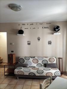 a bedroom with a bed and a wall with drawings on it at Turi house in Messina