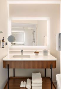 a bathroom with a sink and a mirror at Hyatt Regency New Brunswick in New Brunswick