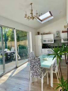 a kitchen with a table and chairs and a dining room at Large One Bedroom House near Twickenham stadium in Isleworth